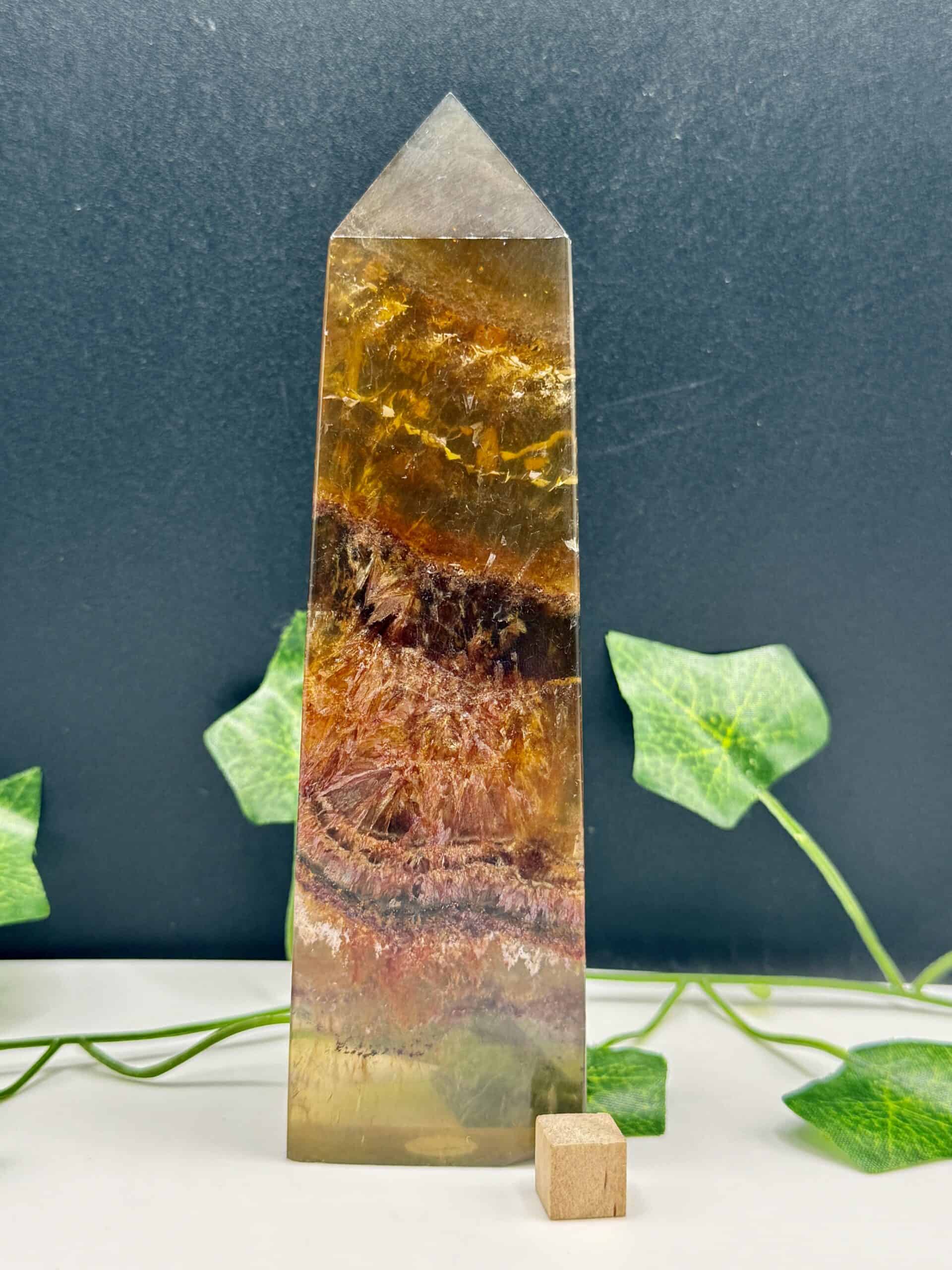 Beautiful multi-colored healing crystal obelisk with natural patterns, ideal for energy healing, meditation, and spiritual practices.