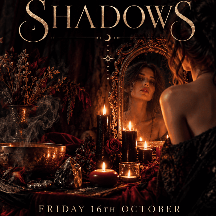 Woman gazing into a mirror surrounded by candles and mystical decor for the Samhain Ritual Sound Bath event.