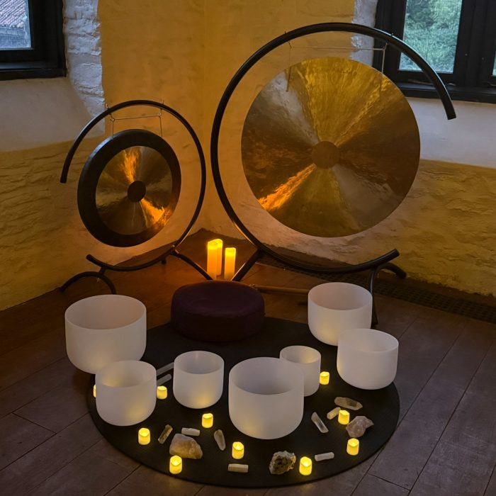 Gong meditation space with crystal bowls and candle lighting for relaxation and healing at The Goddess Haven UK.