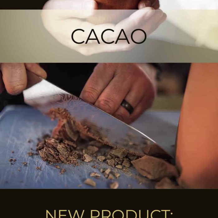 Hand holding a cup of warm cacao with a background of cacao powder and a knife, promoting Spirit Bird Ceremonial Grade Cacao for spiritual and wellness practices.