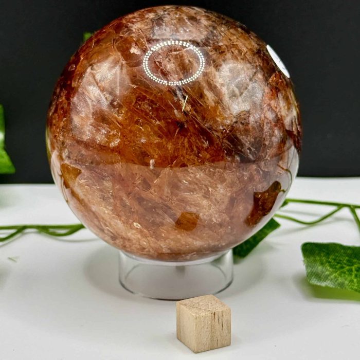 Natural brown quartz crystal sphere for healing and meditation, showcasing polished surface and unique mineral patterns, ideal for spiritual practices and energy balancing.