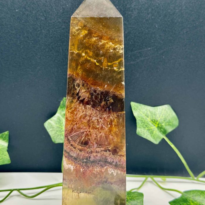 Beautiful multi-colored healing crystal obelisk with natural patterns, ideal for energy healing, meditation, and spiritual practices.